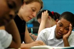 A teacher works with one of her students